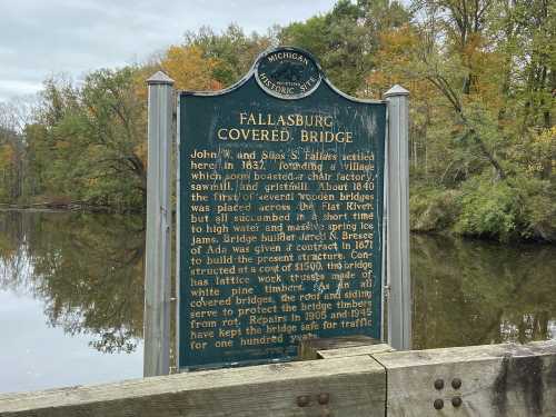 Historical marker about Fallasburg Covered Bridge, detailing its construction and significance in Michigan's history.