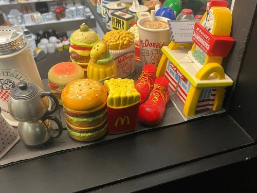 A display of colorful fast food-themed collectibles, including burgers, fries, and a McDonald's figurine.