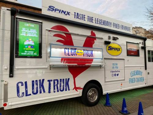 A food truck named "Cluk Truk" featuring a chicken logo and signage promoting legendary fried chicken.