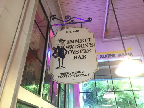Sign for Emmett Watson's Oyster Bar, established in 1978, featuring beer, wine, and food for thought.