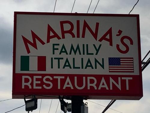 Sign for "Marina's Family Italian Restaurant" featuring Italian and American flags.