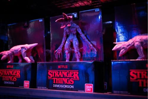 Display of "Stranger Things" action figures, featuring a Demogorgon and Demodogs in colorful packaging.
