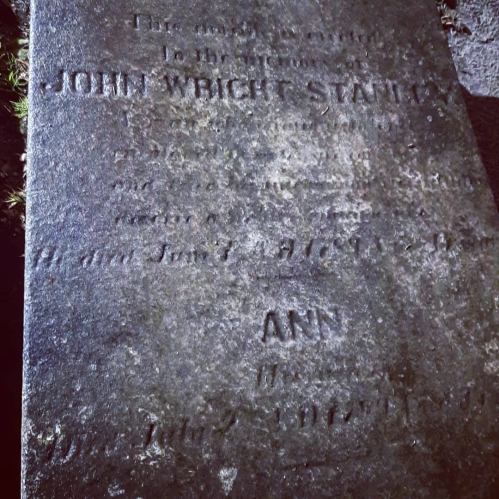 A weathered gravestone with the inscription "John Wright Stanton" and the name "Ann" partially visible.