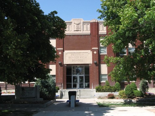 Front view of Preston Senior High School, featuring brick architecture and landscaped greenery.