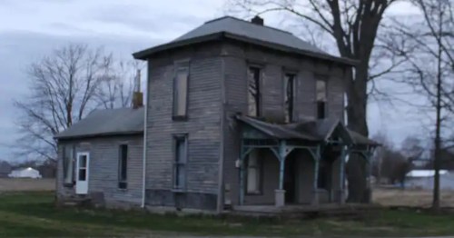 Abandoned two-story historic farmhouse at Revenant Acres Farm, a haunted Indiana attraction.