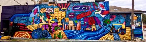 Colorful mural featuring abstract designs, landmarks, and vibrant patterns on a building wall.