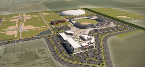 Aerial view of a sports complex featuring baseball fields, a large dome, and surrounding facilities and parking areas.