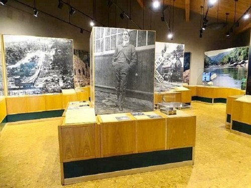 A museum exhibit featuring large photographs and displays, showcasing historical images and artifacts.