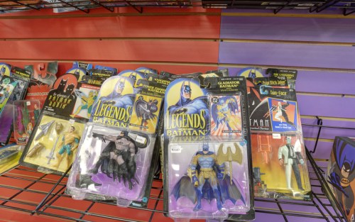 A display of Batman action figures in packaging, featuring various characters from the Batman universe.