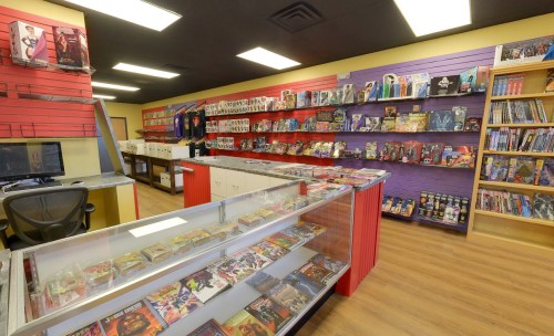 A colorful comic book store interior with shelves of action figures, collectibles, and a display case of comics.