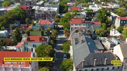 Aerial view of a colorful neighborhood with trees and rooftops, promoting a true crime special event on Oxygen.