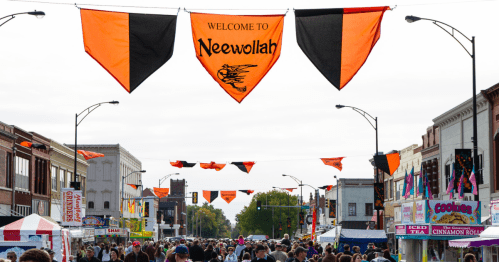 black and orange flags strung up along the streets of downtown independence kansas welcoming festival attendees to neewollah, the city's annual halloween festival