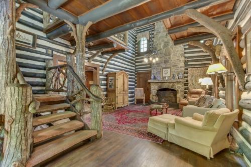 Cozy log cabin interior featuring a stone fireplace, wooden staircase, and rustic furniture. Warm and inviting atmosphere.