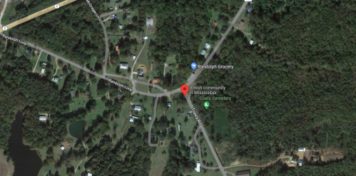Aerial view of an Amish community in Mississippi, featuring roads, homes, and Coats Cemetery.