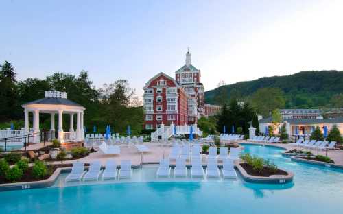 A scenic pool area with lounge chairs, a gazebo, and a historic building in the background, surrounded by greenery.