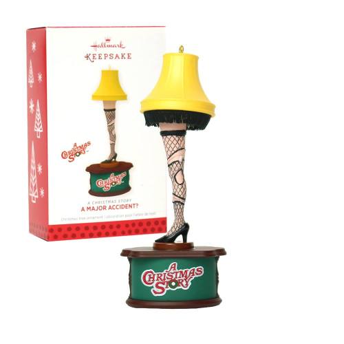 A decorative lamp with a fishnet stocking leg, inspired by "A Christmas Story," next to its festive box.