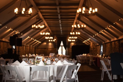 Elegant banquet hall with tables set for dining, soft lighting, and a warm, inviting atmosphere.