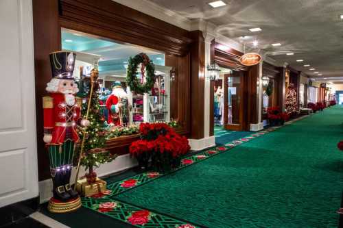 A festive hallway decorated for Christmas, featuring a nutcracker, wreaths, and holiday displays in shop windows.