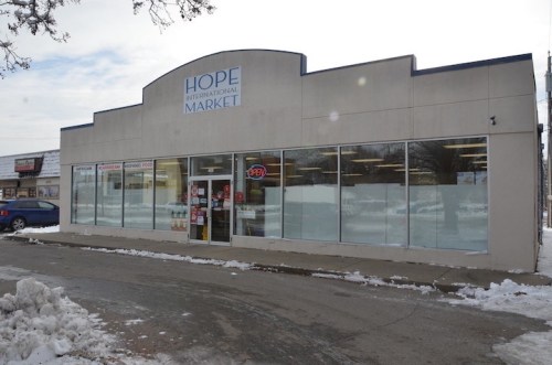 Exterior of Hope International Market, featuring large windows and a snowy parking lot. "Open" sign visible.