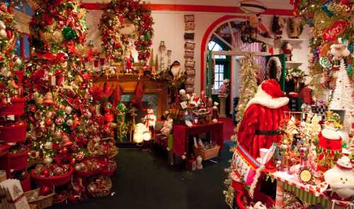 A festive room filled with Christmas decorations, including a large tree, ornaments, and Santa-themed decor.