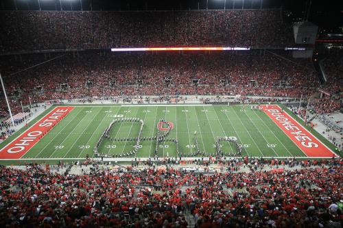 Aerial view of a packed stadium with fans in red, forming the Ohio State logo on the football field.