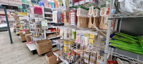 A store aisle filled with various kitchen utensils, tools, and supplies on display.