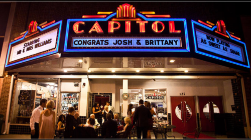 The Capitol theater marquee displays "Congrats Josh & Brittany" with people gathered outside in celebration.
