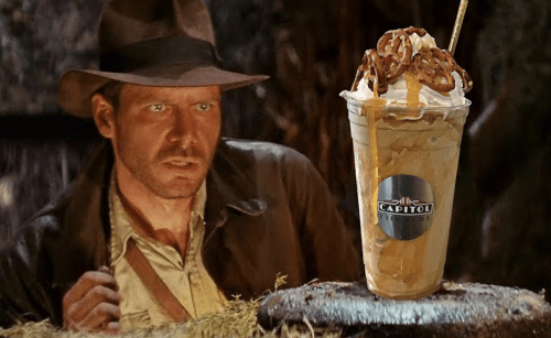 A scene featuring a surprised adventurer next to a large, topped milkshake with pretzels and a straw.