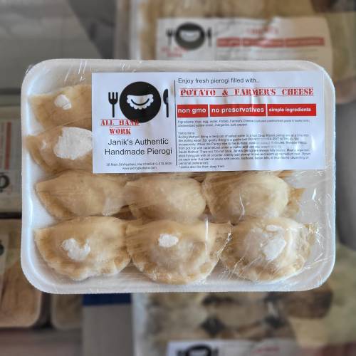 A tray of handmade pierogi filled with potato and farmer's cheese, labeled with ingredients and brand information.