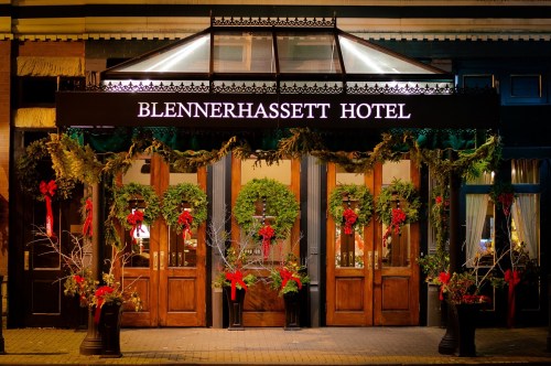 The Blennerhassett Hotel entrance decorated with wreaths and red bows for the holiday season.