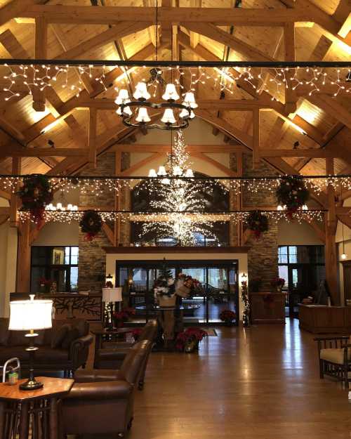 Cozy lodge interior with wooden beams, festive lights, and holiday decorations, creating a warm, inviting atmosphere.