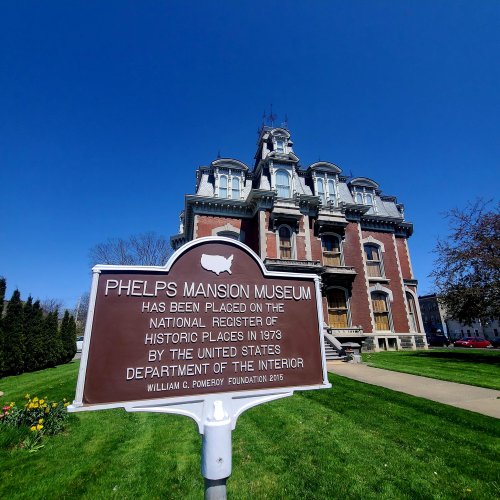 Historic Phelps Mansion Museum with a sign detailing its registration on the National Register of Historic Places.