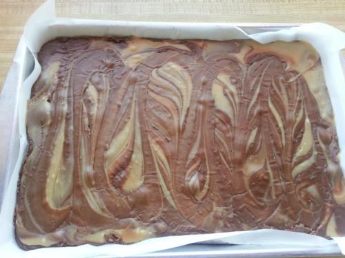 A rectangular tray of swirled chocolate and caramel dessert, with a smooth, glossy surface.