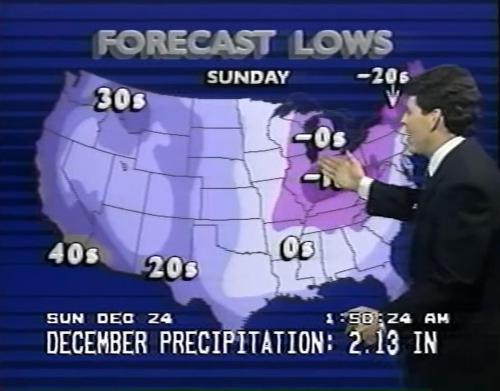 A weather presenter points to a map showing forecast lows across the U.S. for Sunday, with temperatures ranging from -20s to 40s.