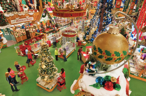 A festive holiday shop filled with colorful decorations, Christmas trees, and shoppers enjoying the seasonal atmosphere.