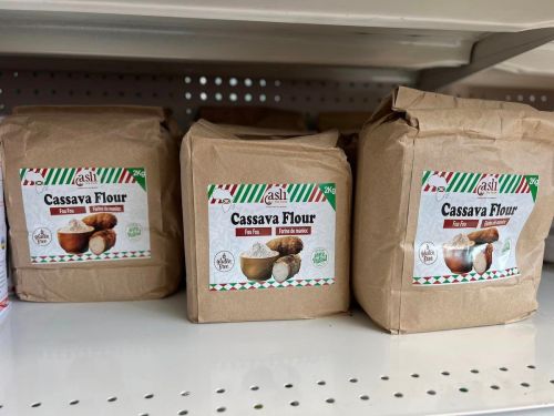 Three packages of cassava flour on a store shelf, each with a brown paper bag and labeled clearly.