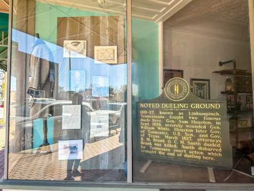 Sign and historical display about the Linkumpinch dueling ground, featuring images and text about its significance.