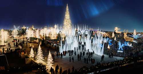 A festive winter scene with illuminated trees, ice sculptures, and crowds enjoying a holiday light display at night.