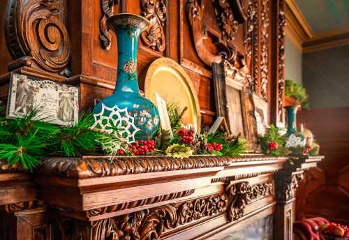 A wooden mantel adorned with greenery, decorative vases, and festive accents, creating a warm holiday atmosphere.