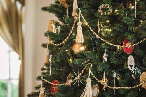 A beautifully decorated Christmas tree adorned with ornaments, garlands, and twinkling lights.