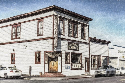 Historic building with a sign for a hotel and saloon, featuring a classic Western architectural style.