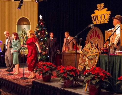 A vintage performance scene with singers on stage, a Christmas tree, and festive decorations in a cozy setting.