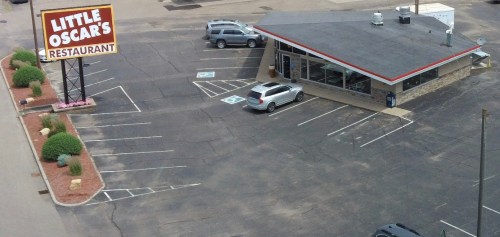 Aerial view of Little Oscar's Restaurant with a parking lot and several cars parked outside.