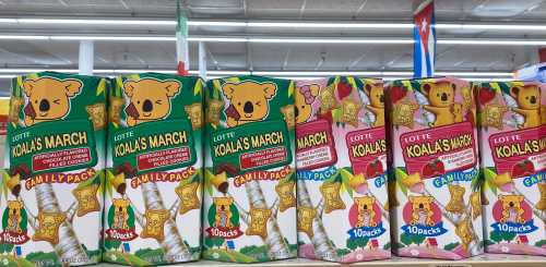 Colorful boxes of Lotte Koala's March snacks lined up on a store shelf, featuring koala characters and various flavors.