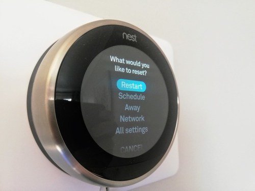 A Nest thermostat displaying a reset menu with options for Schedule, Away, Network, and All settings.