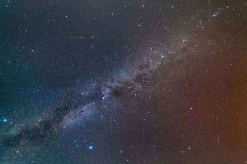 A stunning view of a starry galaxy, featuring a bright band of stars and cosmic dust against a dark background.