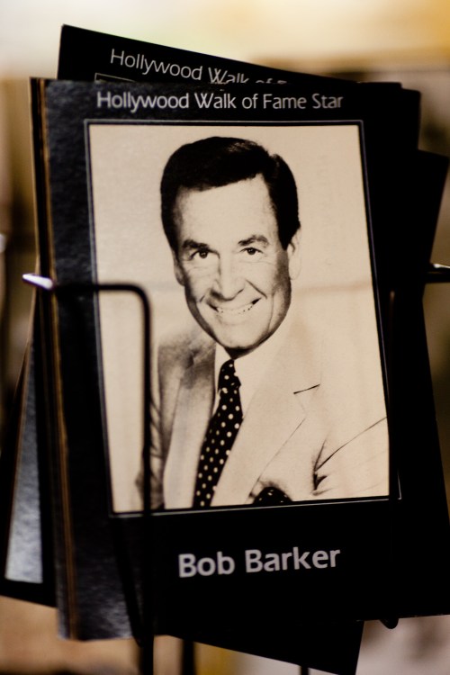 Black and white photo of Bob Barker with a polka dot tie, featured on a Hollywood Walk of Fame display.