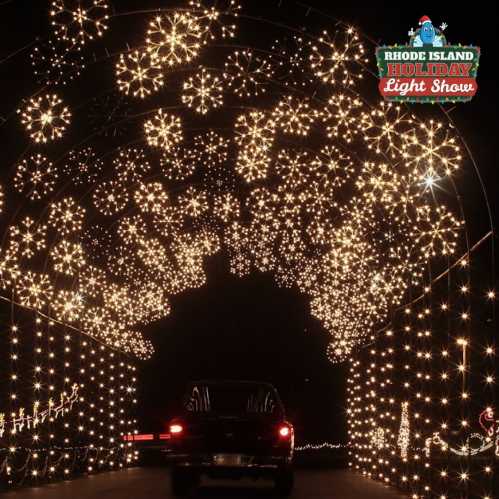 A car drives through a dazzling light display featuring snowflake patterns at the Rhode Island Holiday Light Show.