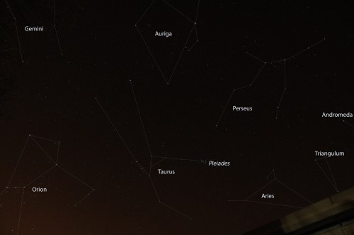A night sky filled with stars, featuring labeled constellations like Gemini, Orion, and Taurus.