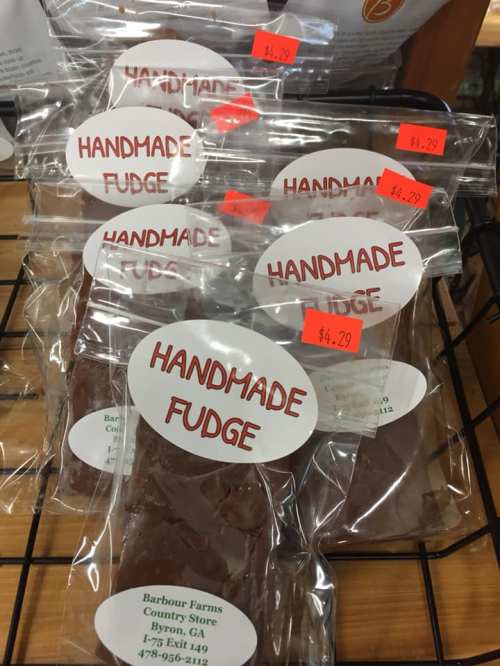 Clear plastic bags of handmade fudge displayed on a rack, with price tags ranging from $4.29 to $4.99.